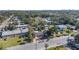 Aerial view showing a red house among other homes, tree-lined streets, and a city skyline in the distance at 229 S Adams St, Daytona Beach, FL 32114