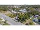 Aerial view of a residential neighborhood with a red house prominently featured amongst other houses and lush greenery at 229 S Adams St, Daytona Beach, FL 32114