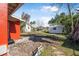 Backyard view, showing house exterior, shed, and landscaping at 229 S Adams St, Daytona Beach, FL 32114