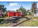 Large backyard with a mostly cleared area at 229 S Adams St, Daytona Beach, FL 32114
