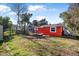 Large backyard with red house and storage shed at 229 S Adams St, Daytona Beach, FL 32114