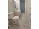 Well lit bathroom featuring tile flooring, a toilet, sink, and a walk-in shower through an open doorway at 229 S Adams St, Daytona Beach, FL 32114