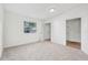 Main bedroom with grey carpet, window, and closet at 229 S Adams St, Daytona Beach, FL 32114