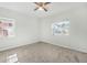 Bright bedroom with carpet flooring, ceiling fan, and window with natural light at 229 S Adams St, Daytona Beach, FL 32114