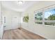 Bright entryway with light wood floors and access to other rooms at 229 S Adams St, Daytona Beach, FL 32114