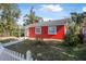 Red brick house with white picket fence and a grassy front yard at 229 S Adams St, Daytona Beach, FL 32114