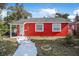 Red brick house with white picket fence and a walkway to the entrance at 229 S Adams St, Daytona Beach, FL 32114