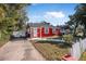 Red brick house with a driveway and white picket fence at 229 S Adams St, Daytona Beach, FL 32114