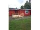 Single story home with a wood deck and stairs; grassy yard at 229 S Adams St, Daytona Beach, FL 32114