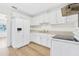 White kitchen with appliances and wood-look floors at 229 S Adams St, Daytona Beach, FL 32114