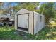 White storage shed with roll up door at 229 S Adams St, Daytona Beach, FL 32114