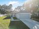 Gray house with a gray garage door and a neatly landscaped front yard at 2373 Weldon Ct, Deltona, FL 32738