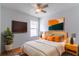 Bright bedroom with a TV and stylish decor at 244 W Fiesta Key Loop, Deland, FL 32720