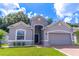 Gray two-story house with a two-car garage and manicured lawn at 244 W Fiesta Key Loop, Deland, FL 32720