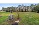 View of backyard featuring trees, grass, and a satellite dish, providing outdoor space at 245 Terrace Hill Blvd # 1E, Debary, FL 32713