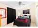 Relaxing bedroom featuring a ceiling fan, a queen size bed, and a large picture window at 245 Terrace Hill Blvd # 1E, Debary, FL 32713