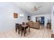 Dining room with wooden table and chairs, a chandelier, and access to the living room at 245 Terrace Hill Blvd # 1E, Debary, FL 32713