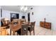 Dining room with wooden table and chairs, a chandelier, and access to the living room at 245 Terrace Hill Blvd # 1E, Debary, FL 32713