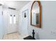Welcoming foyer with tiled floor and decorative mirror creating an inviting entrance at 245 Terrace Hill Blvd # 1E, Debary, FL 32713
