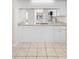 Bright kitchen with stainless steel sink, granite countertops, and white cabinetry at 245 Terrace Hill Blvd # 1E, Debary, FL 32713