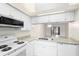 Updated kitchen featuring granite countertops, white cabinets, and stainless steel appliances at 245 Terrace Hill Blvd # 1E, Debary, FL 32713