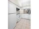 Modern kitchen with white appliances and cabinets, and an open layout at 245 Terrace Hill Blvd # 1E, Debary, FL 32713