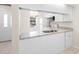 White kitchen with granite countertops and stainless steel appliances offers modern convenience at 245 Terrace Hill Blvd # 1E, Debary, FL 32713