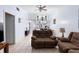 Inviting living room with neutral tile flooring, vaulted ceiling, and a view to the kitchen at 245 Terrace Hill Blvd # 1E, Debary, FL 32713