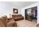 Comfortable living room featuring tile floors and sliding glass doors leading to the outdoors at 245 Terrace Hill Blvd # 1E, Debary, FL 32713