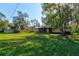 Spacious backyard with grassy lawn and screened porch at 2608 Treehaven Dr, Deltona, FL 32738
