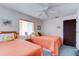 Cozy bedroom with two twin beds and ceiling fan at 2608 Treehaven Dr, Deltona, FL 32738