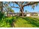 Ranch-style home with mature landscaping and a large tree at 2608 Treehaven Dr, Deltona, FL 32738