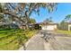 Front view of the house with a large oak tree at 2608 Treehaven Dr, Deltona, FL 32738