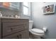 Bathroom features gray vanity with a white toilet at 262 Valencia Rd, Debary, FL 32713