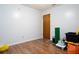 Simple bedroom with wood-look floors and neutral walls at 262 Valencia Rd, Debary, FL 32713
