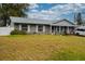 Ranch-style home with brick facade, spacious yard, and American flag at 262 Valencia Rd, Debary, FL 32713