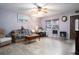 Living room features light wood floors, comfy seating, and a ceiling fan at 262 Valencia Rd, Debary, FL 32713