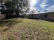 Large backyard with grassy area and mature tree at 2709 Queen Palm Dr, Edgewater, FL 32141