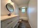 Bathroom featuring modern vanity with stylish mirror, bathtub and natural lighting at 2709 Queen Palm Dr, Edgewater, FL 32141