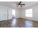 Bright bedroom with wood-look floors and access to bathroom at 2709 Queen Palm Dr, Edgewater, FL 32141