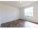 Bright bedroom with hardwood floors and a large window at 2709 Queen Palm Dr, Edgewater, FL 32141