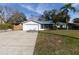 Front view of house with driveway and lawn at 2709 Queen Palm Dr, Edgewater, FL 32141