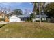 Front view of house with driveway and lawn at 2709 Queen Palm Dr, Edgewater, FL 32141