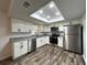 Bright kitchen featuring stainless steel appliances, white cabinets, and granite countertops at 2709 Queen Palm Dr, Edgewater, FL 32141