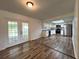 Open layout showcasing the kitchen with stainless steel appliances, white cabinets and a breakfast area with french doors at 2709 Queen Palm Dr, Edgewater, FL 32141