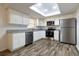 Modern kitchen with white cabinets and stainless steel appliances at 2709 Queen Palm Dr, Edgewater, FL 32141