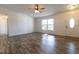 Living room with hardwood floors, a window, and an entryway at 2709 Queen Palm Dr, Edgewater, FL 32141