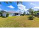 Spacious backyard with screened patio overlooking a peaceful lake at 2758 Turnbull Cove Dr, New Smyrna Beach, FL 32168