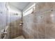 Tiled bathroom with a glass-enclosed shower at 2758 Turnbull Cove Dr, New Smyrna Beach, FL 32168