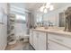 Clean bathroom with white cabinets and tiled shower at 2758 Turnbull Cove Dr, New Smyrna Beach, FL 32168